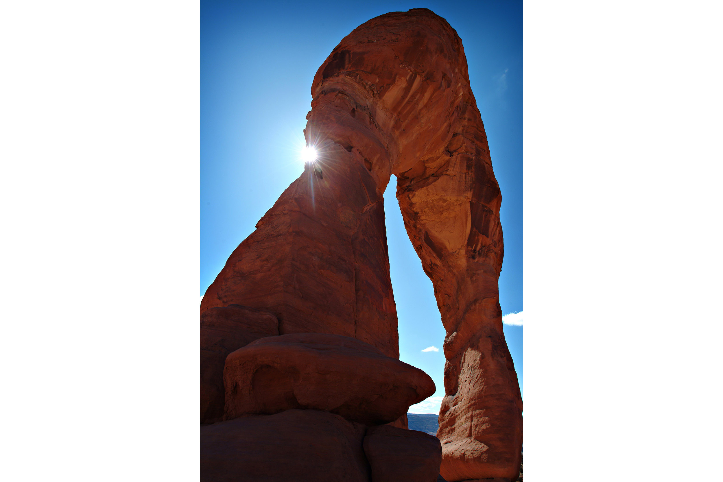 The sun plays hide and seek with Delicate Arch