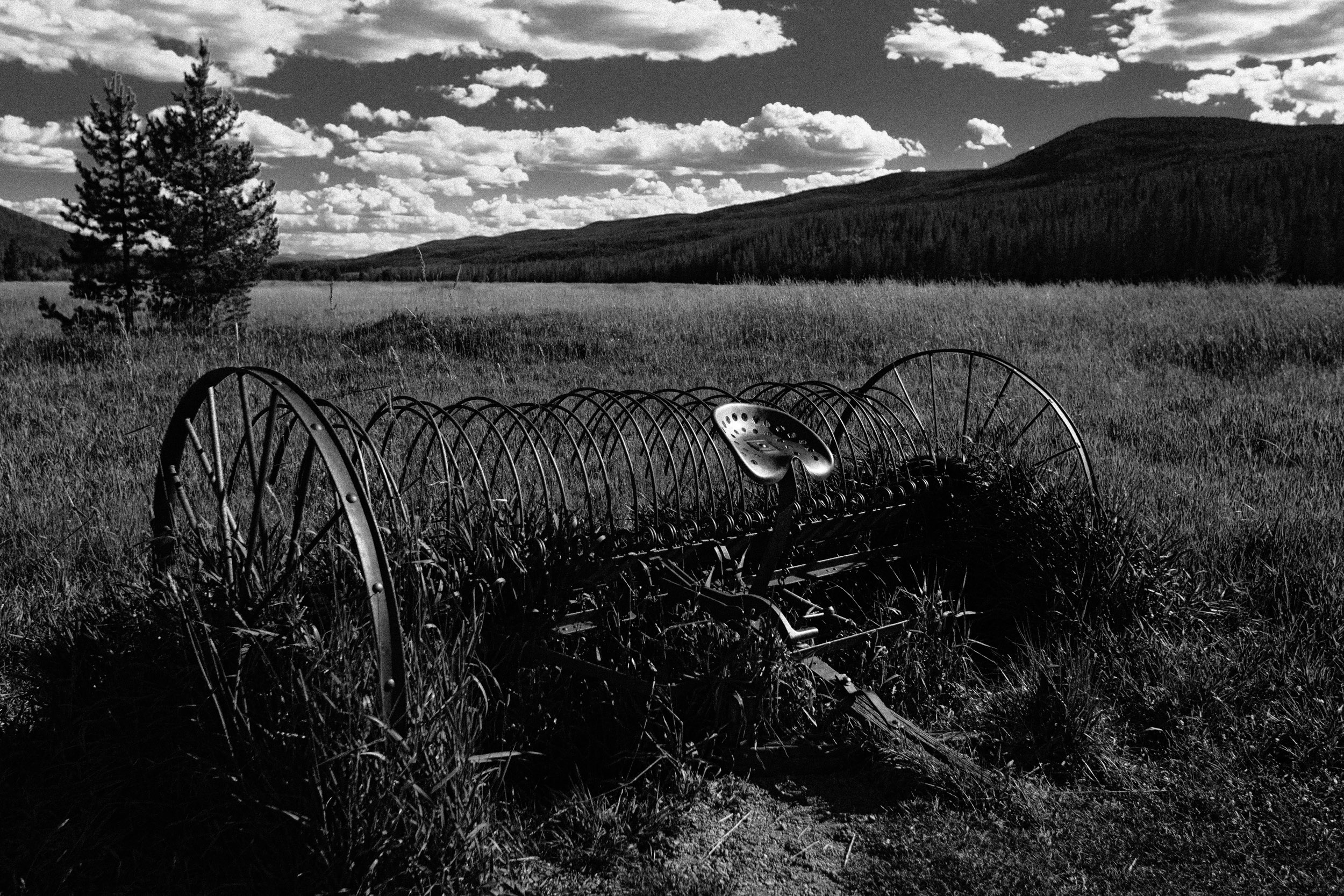 Abandoned farm equipment in a Rocky Mountain valley