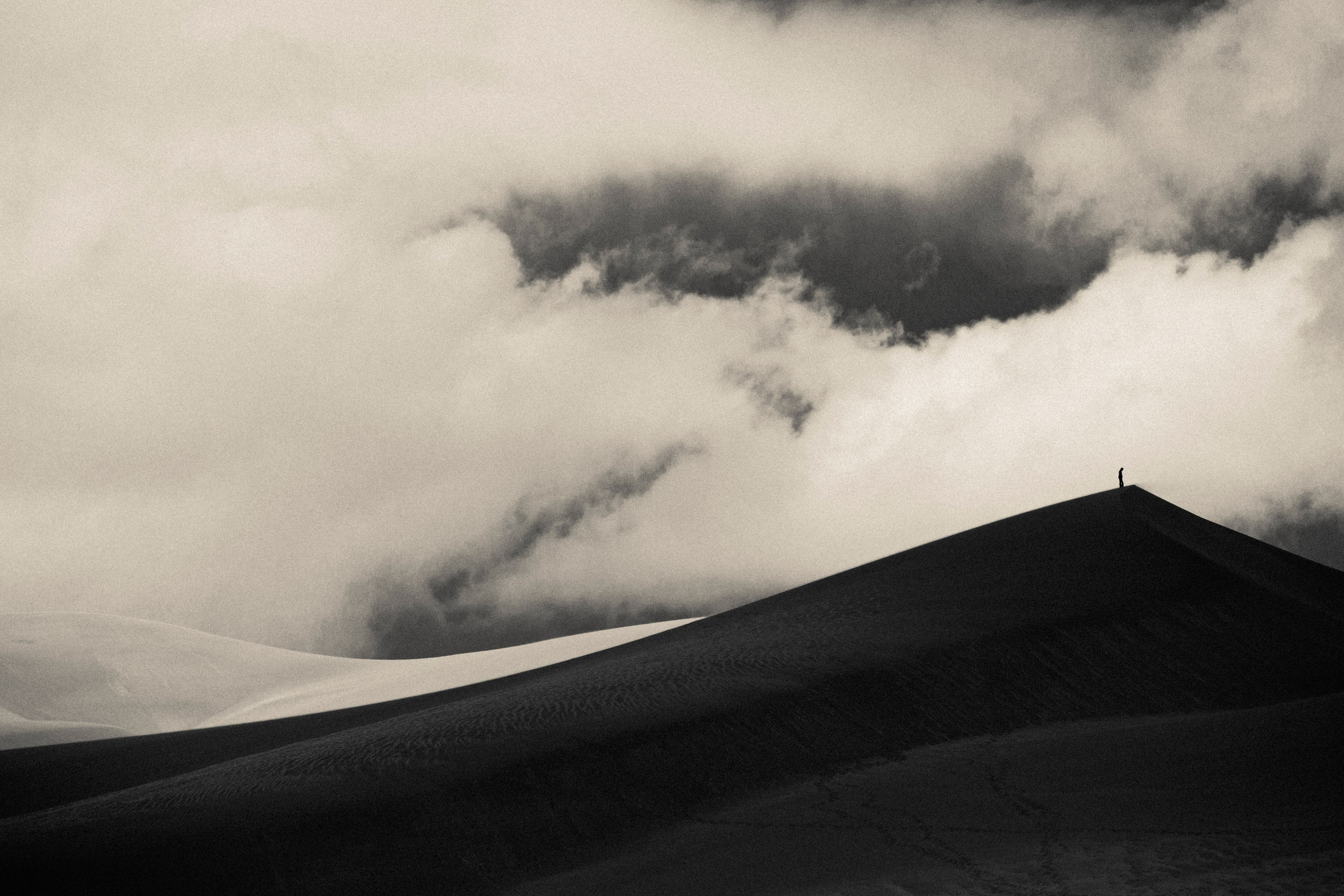 A solo hiker atop a sand dune at Great Sand Dunes National Park