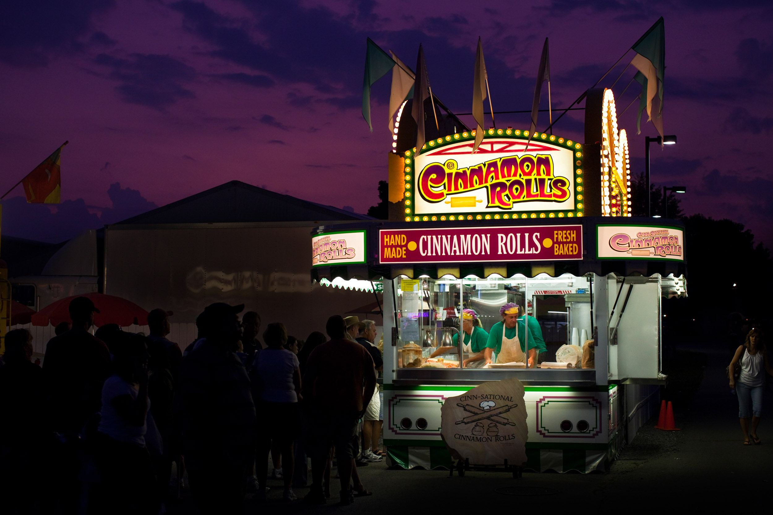 Patrons line up after dark for the Cinnamon Rolls cart