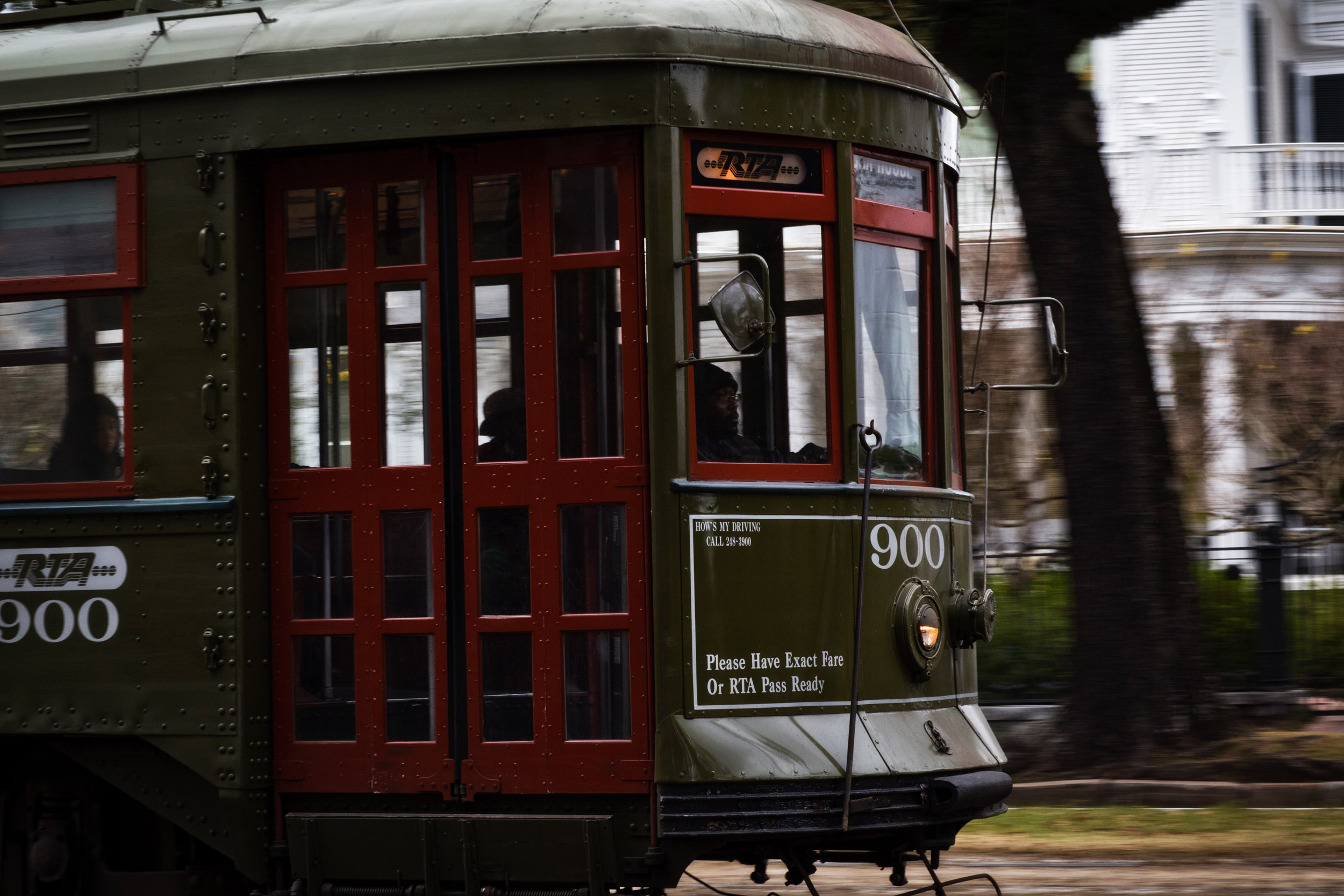 A sparsely filled streetcar hums along St. Charles Avenue